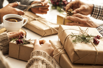 People hands wrap gift boxes
