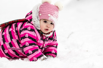 Cute little girl having fun outdoor on nature at winter.