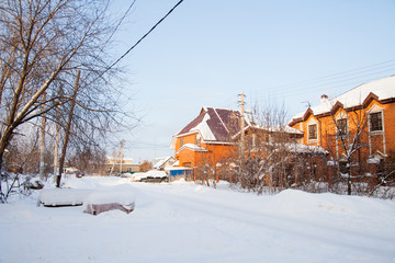 Winter rural landscape with brick cottages