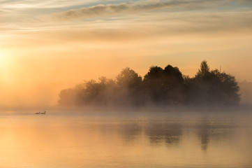 tranquil sunrise lake with fog