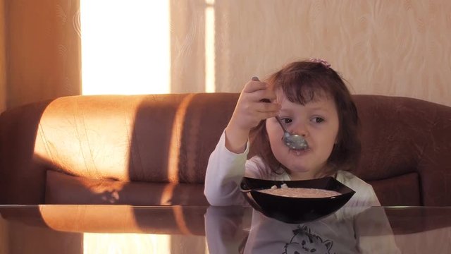 Beautiful child eats breakfast