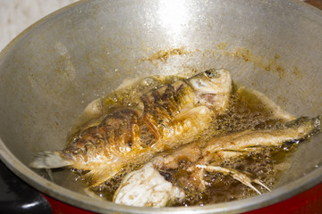 freshwater fish fried in a pan