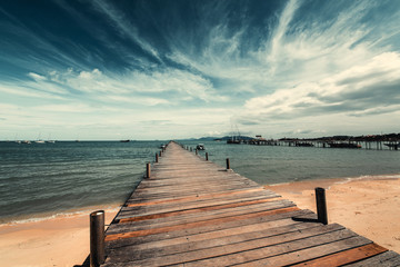 Fototapeta na wymiar Wooden pier on the sandy shore.