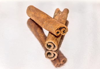 Cinnamon on  reflective background.