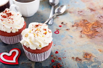 Delicious red velvet cupcakes for Valentines Day on rusty old metal background. Holiday food concept. Copy space.