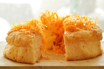 golden egg threads cake cut for piece on wooden chop block