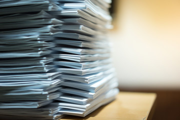 Piles of paper stacked on a table.