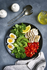 Salad bowl with vegetables,lamb lettuce and chicken.Top view.