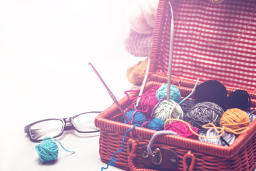 beautiful still life with clews wool yarn in a basket