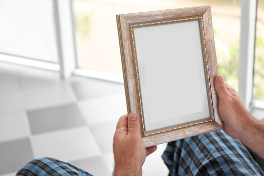 Man holding and looking at photo