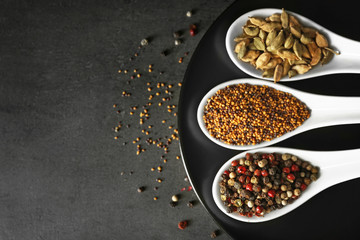 Different spices in spoons on plate