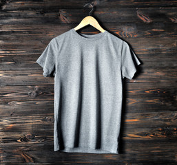 Blank grey t-shirt against wooden background