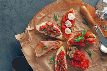 Tasty bruschetta on cutting board, top view