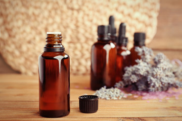 Fototapeta na wymiar Essential oils and lavender on wooden table