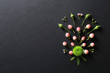 Composition of flowers and leaves on black background