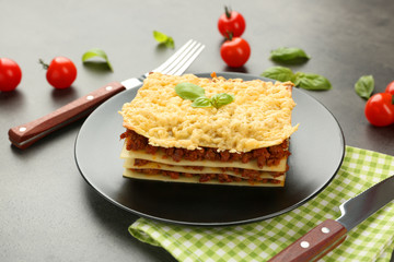 Portion of tasty lasagna on table