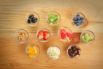 Healthy eating concept. Assortment of products in bowls on wooden background