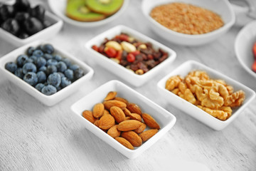Healthy eating concept. Assortment of products in bowls on wooden background