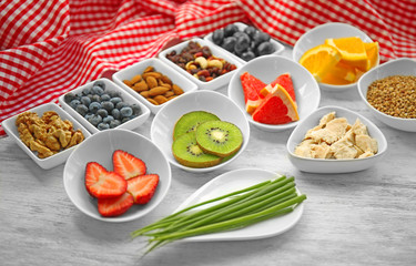Healthy eating concept. Assortment of products in bowls on wooden background