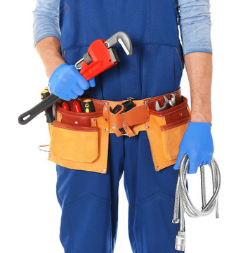 Plumber with tools on white background, closeup