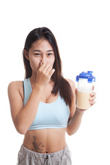Beautiful Asian healthy girl hate whey protein smell.