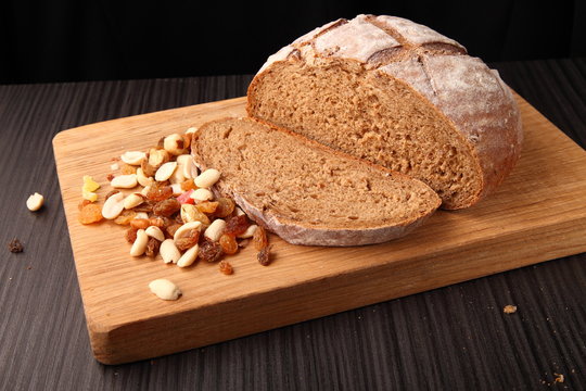bread and nuts with raisins on oak/ bread and nuts with raisins on oak