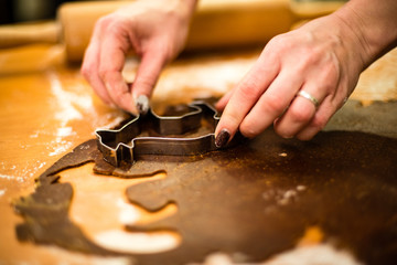 Fototapeta na wymiar Making Gingerbread Cookies Series. Cutting dough sheet into shap