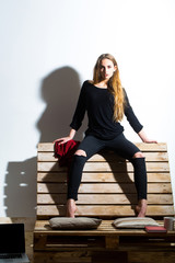 Pretty girl sits on backrest