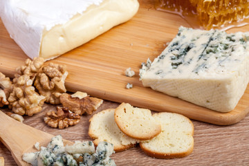 Healthy food. Differet type of cheese on wooden background