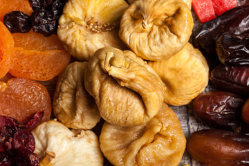 Close up image of dried fruits on wooden background