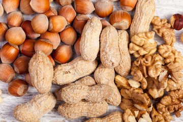 Different type of nuts on wooden background