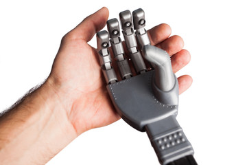 human hand holding robotic hand