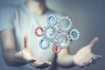 Close up of businessman holding gears in palms