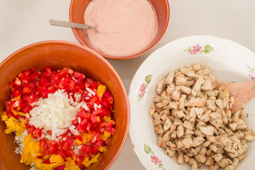 cut food ingredients in plates, grilled chicken and pepper 