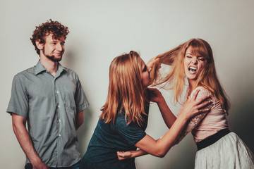 Aggressive mad women fighting over man.