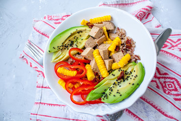 Brown rice with avocado, peppers and tofu. Vegan healthy lunch or dinner. Love for a healthy raw food concept.