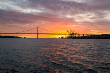 Panoramic views of the Tagus River, Bridge April 25 Lisbon and  port at sunset from ship, Portugal.