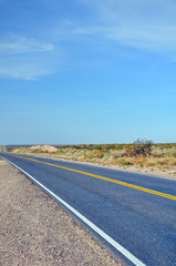 Fototapeta premium Close up asphalt with yellow lines at La Pampa dessert in Patagonia, Argentina