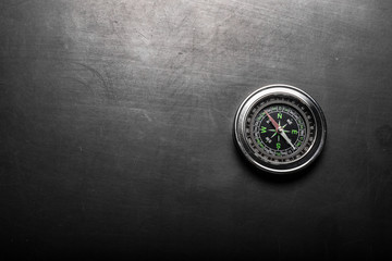 Compass on black board background