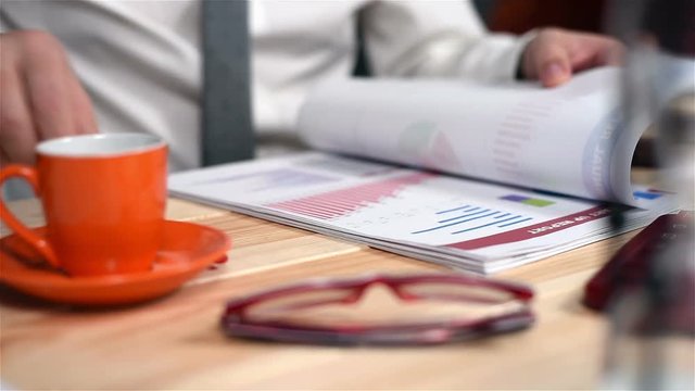 Businessman Monitoring Stock Statistics. Close Up