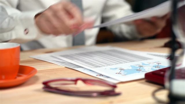 Businessman Collects Documents And  Financial Report On Table
