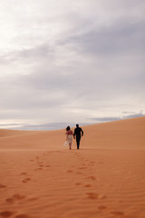 Fototapeta na wymiar couple travel sand dune