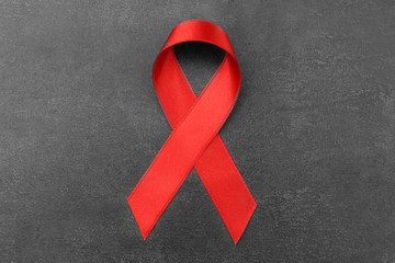 Red ribbon on grey background. Aids concept