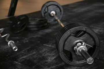 Fototapeta na wymiar Close up view of barbell on floor in gym
