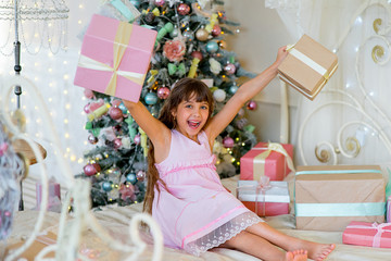 Adorable blonde girl with Christmas gifts