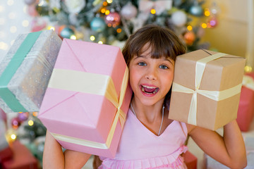Adorable blonde girl with Christmas gifts