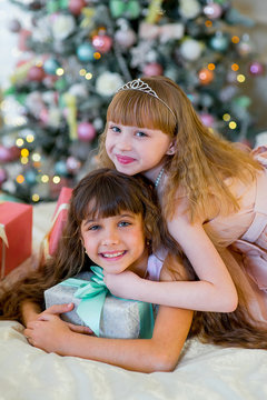 Two adorable girls with Christmas gifts