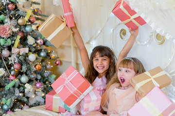 Two adorable girls with Christmas gifts