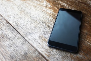 mobile phone on wood table background