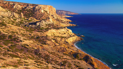 Scenic views of the sea from a height. Red Beach is located near the village of Matala, Crete. Forbidding coast of the Libyan Sea. Sandstone cliffs.